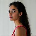 Portrait of Maya Patel, a female cyclist with protective gear.